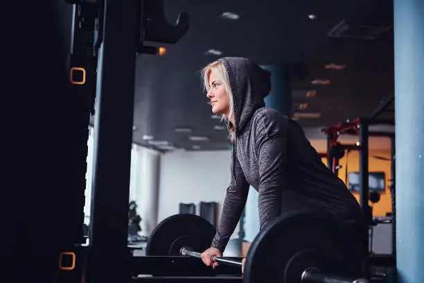 girl doing workout while wearing hoodie